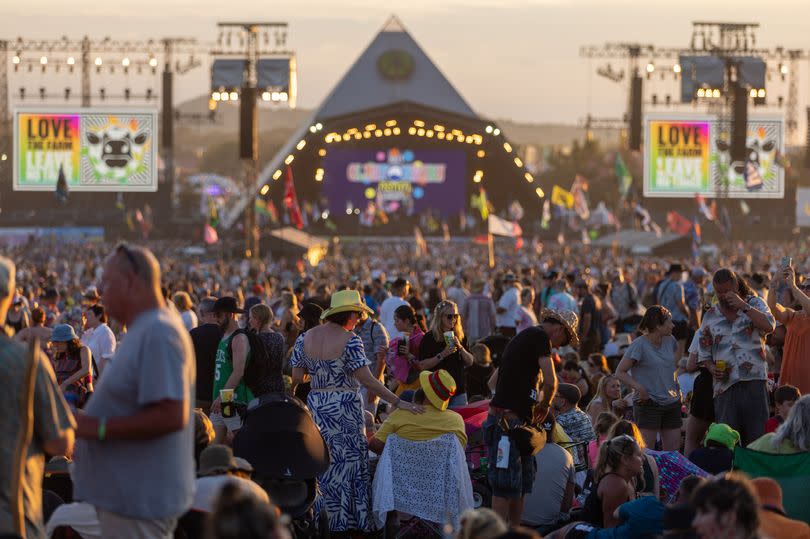 GLASTONBURY, ENGLAND - JUNE 24: Crowds gather to watch the main acts performing on the main Pyramid Stage as the sun begins to set on Day 4 of the Glastonbury Festival 2023 held at Worthy Farm, Pilton on June 24, 2023 in Glastonbury, England. The festival, founded in 1970, has grown into one of the largest outdoor green field festivals in the world. (Photo by Matt Cardy/Getty Images)