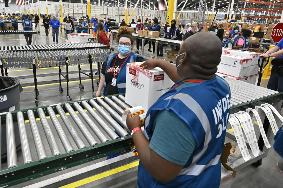 The first box containing the Johnson & Johnson COVID vaccine heads down the conveyor to an awaiting transport truck at the McKesson facility in Shepherdsville, Ky., Monday, March 1, 2021. (Timothy D. Easley/AP Photo)