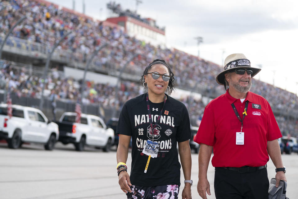 University of South Carolina women's basketball coach Dawn Staley, left, walks on the track at Darlington Raceway with Brent Childress before the Southern 500 NASCAR auto race Sunday, Sept. 4, 2022, in Darlington, S.C. Staley was the honorary pace car driver. (AP Photo/Sean Rayford)