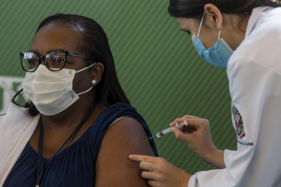 Nurse Monica Calazans, 54, is the first Brazilian to receive the COVID-19 vaccine produced by China’s Sinovac Biotech Ltd, at the Hospital das Clinicas in Sao Paulo, Brazil, Sunday, Jan. 17, 2021. (AP Photo/Carla Carniel)