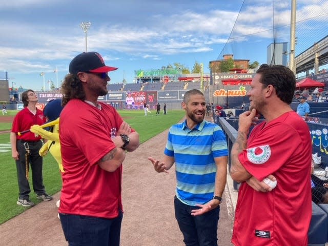 Former Boston Red Sox Jarrod Saltalamacchia, left, and Jake Peavy chat with Red Sox director of player development Brian Abraham before taking part in the ceremonial first pitch Tuesday night at Polar Park.
