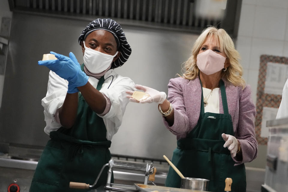 U.S. first lady Jill Biden, right, shows the dough as she helps making ravioli in culinary class during a visit to Naples Middle High School, a Department of Defense Education Activity (DoDEA) school, after attending events on the sidelines of the G20 summit in Rome, Monday, Nov. 1, 2021. (AP Photo/Alessandra Tarantino)