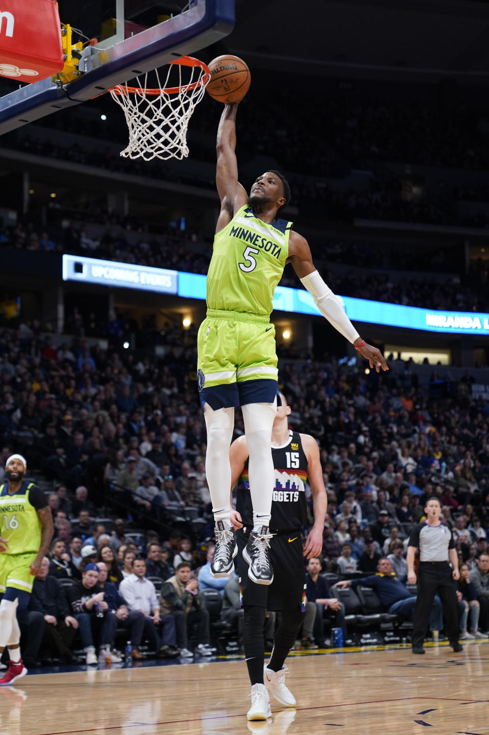 Minnesota Timberwolves guard Malik Beasley (5) dunks against the Denver Nuggets during the first quarter of an NBA basketball game Sunday, Feb. 23, 2020, in Denver (AP Photo/Jack Dempsey)