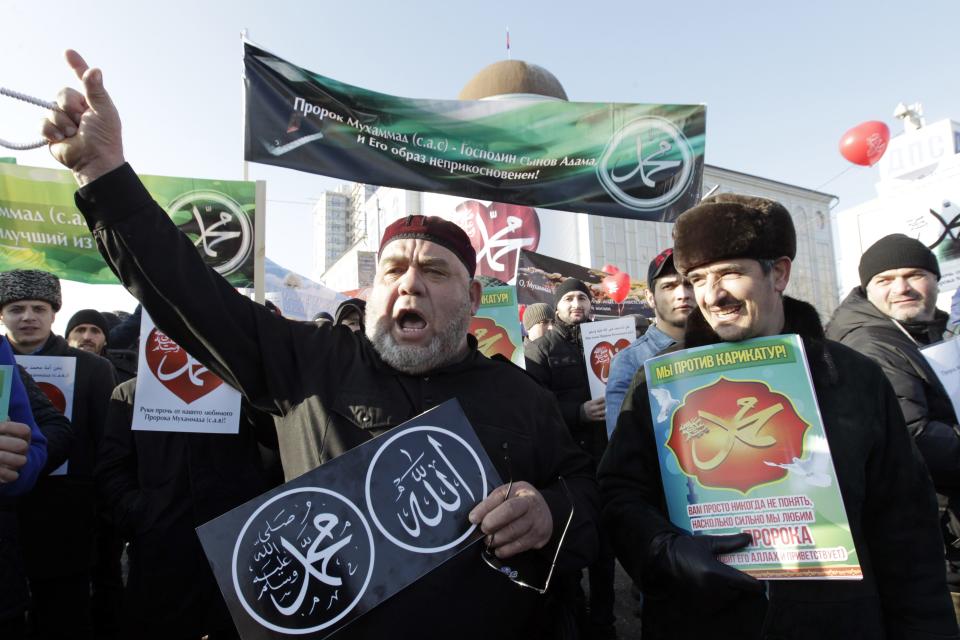 People attend a rally to protest against satirical cartoons of prophet Mohammad, in Grozny, Chechnya