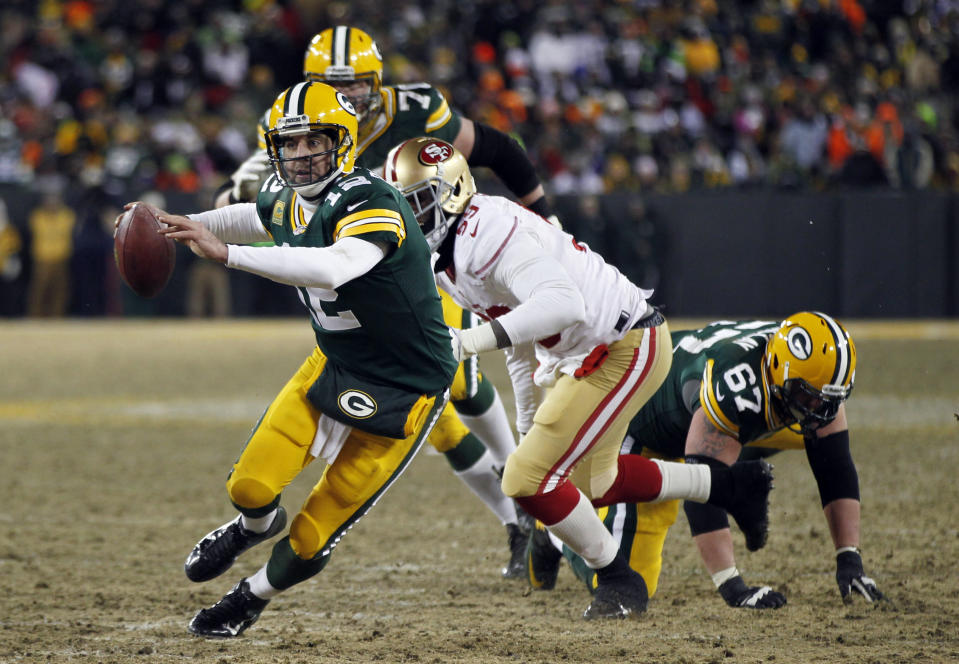 Green Bay Packers quarterback Aaron Rodgers (12) scrambles during the second half of an NFL wild-card playoff football game, Sunday, Jan. 5, 2014, in Green Bay, Wis. The 49ers won 23-20. (AP Photo/Mike Roemer)