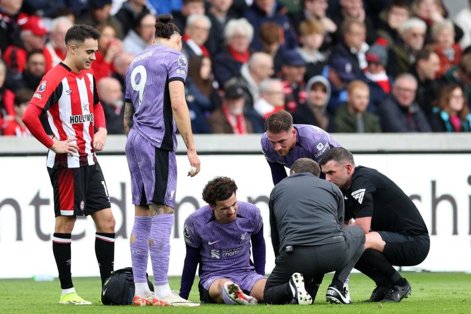 Curtis Jones is treated by medical staff in Liverpool’s game against Brentford (AFP via Getty Images)