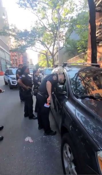 PHOTO: In this screen grab posted to the Twitter account of the NYPD 19th Precinct, police officers are shown rescuing the dog from a hot car after a passerby reported the distressed animal. (@NYPD19Pct/Twitter)