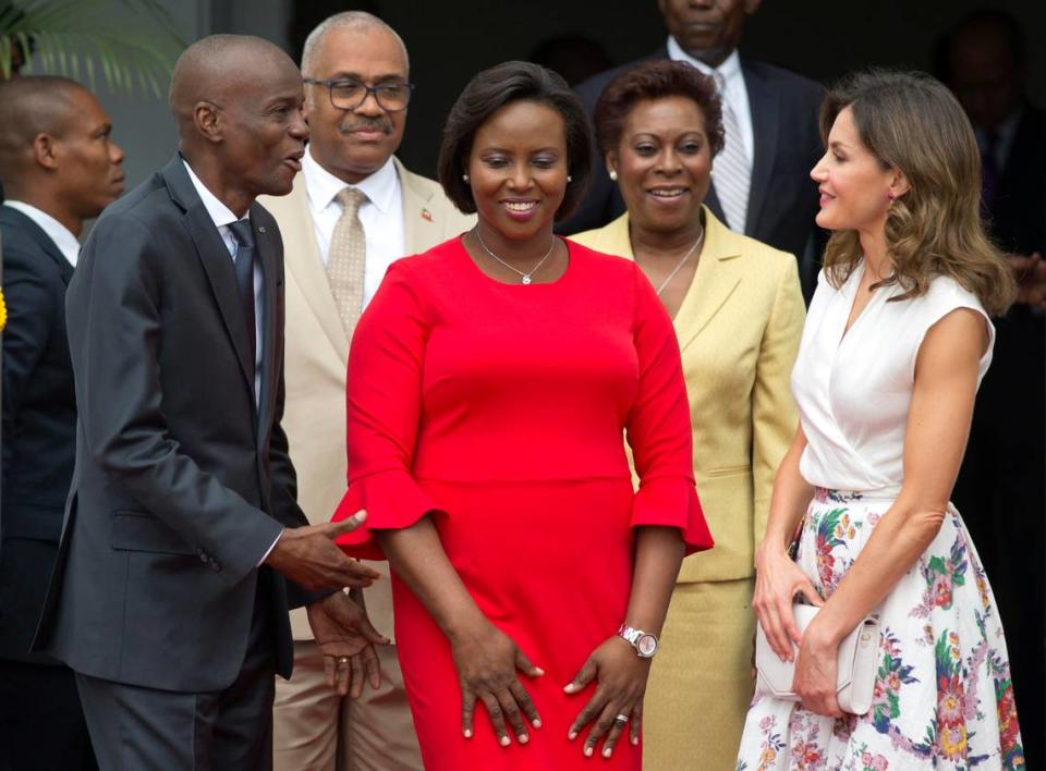 Martine Moïse, in red, was wounded in the attack that killed her husband, President Jovenel Moïse, standing next to her. This photo shows them three years earlier during a 2018 event at the National Palace.