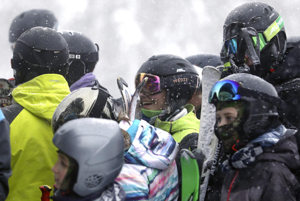 Skiers wait in a lift line on Mount Jahorina, 30 kilometers south of the Bosnian capital of Sarajevo, Saturday, Dec. 11, 2021. As most of Europe reintroduces measures to help curb the spread of the omicron variant, Bosnia, to the delight of its winter tourism industry, still maintains a relatively laissez-fair approach to the soaring COVID-19 infection numbers across the continent. (AP Photo/Marjan Vucetic)