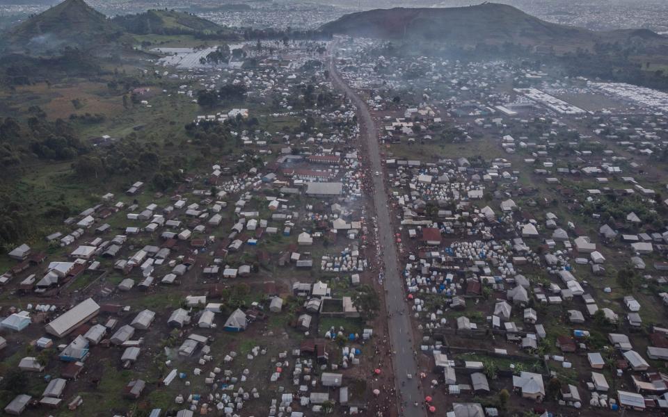 This aerial view shows internally displaced persons (IDP) houses and the host community on National Road 2 between the city of Goma and Kibati, eastern Democratic Republic of the Congo, December 5, 2022 - GUERCHOM NDEBO/AFP via Getty Images