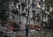 A resident looks at a damaged building after a rocket attack early Wednesday morning, in Kramatorsk, eastern Ukraine, Wednesday, Aug. 31, 2022. (AP Photo/Kostiantyn Liberov)