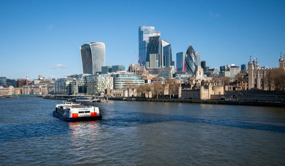 a boat in the water with a city in the background