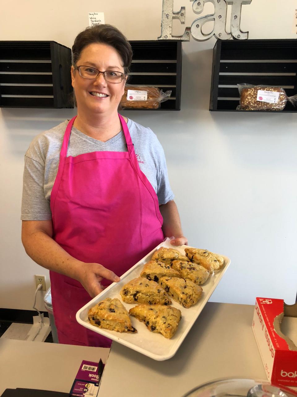 Lynnette Casazza, owner of Mama C's Gluten Free Bakery, gets ready to put freshly baked cranberry scones in the showcase.