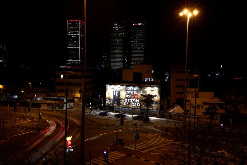 A billboard over a Tel Aviv highway shows photo-shopped warzone images of Palestinian President Mahmoud Abbas and Hamas leader Ismail Haniyeh, both blindfolded, with the slogan read in Hebrew "Peace is Made ONLY with Defeated Enemies\