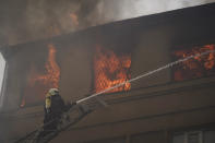 A firefighter works to extinguish a fire after a Russian attack that damaged a police building in Kharkiv, Ukraine, Monday, Sept. 12, 2022. (AP Photo/Leo Correa)