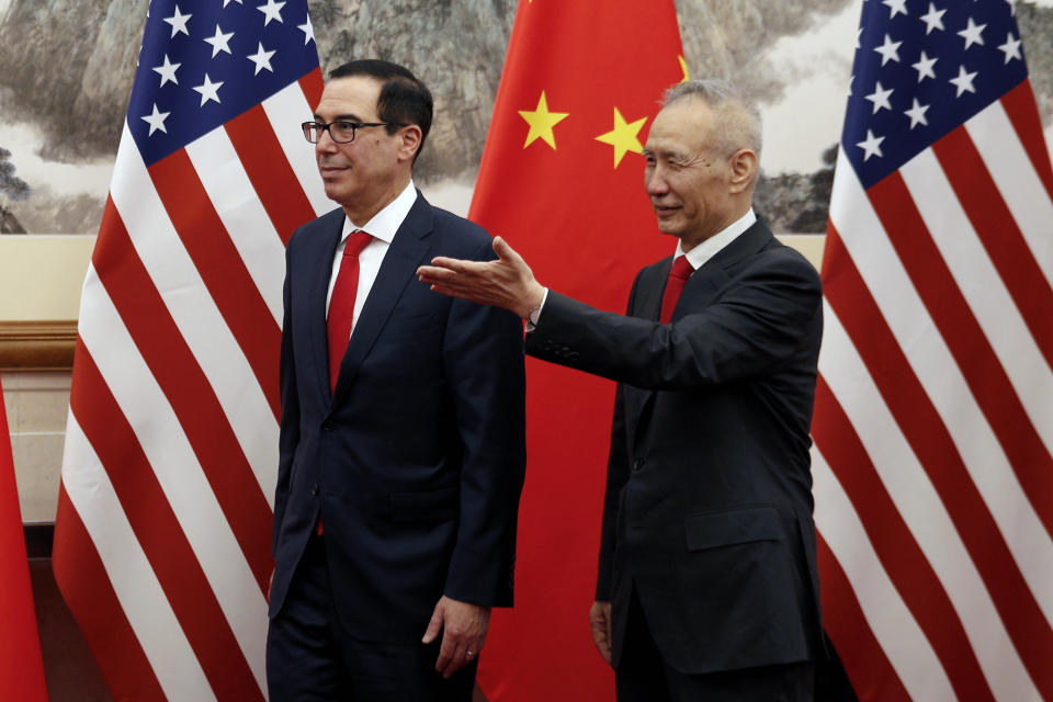 Chinese Vice Premier Liu He, right, shows the way to U.S. Treasury Secretary Steven Mnuchin as they proceed to their meeting at the Diaoyutai State Guesthouse in Beijing, Wednesday, May 1, 2019. (AP Photo/Andy Wong, Pool)