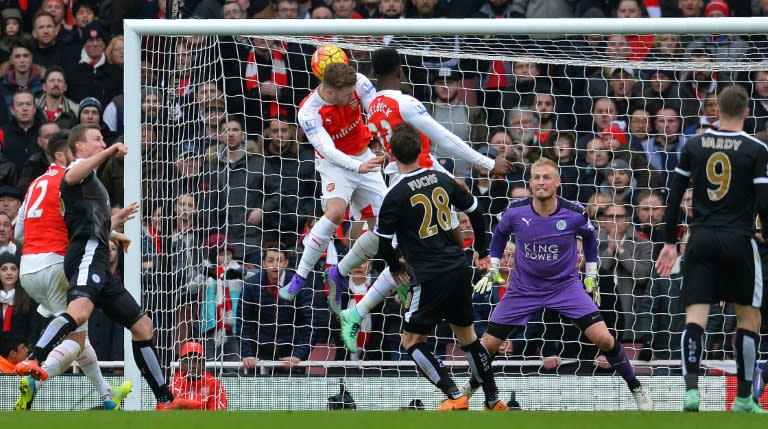 Arsenal striker Danny Welbeck (centre) heads the ball to score his team's second goal during the English Premier League match against Leicester at the Emirates Stadium in London on February 14, 2016