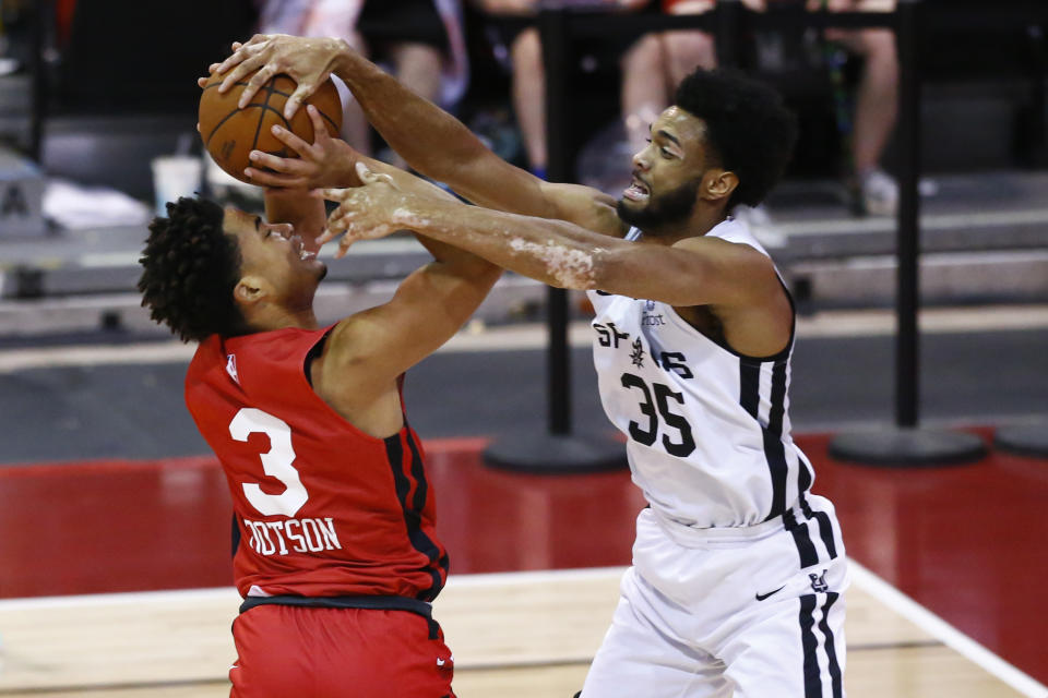San Antonio Spurs' Nate Renfro (35) blocks the shots of Chicago Bulls' Devon Dotson (3) during the first half of an NBA summer league basketball game in Las Vegas on Tuesday, Aug. 10, 2021. (AP Photo/Chase Stevens)