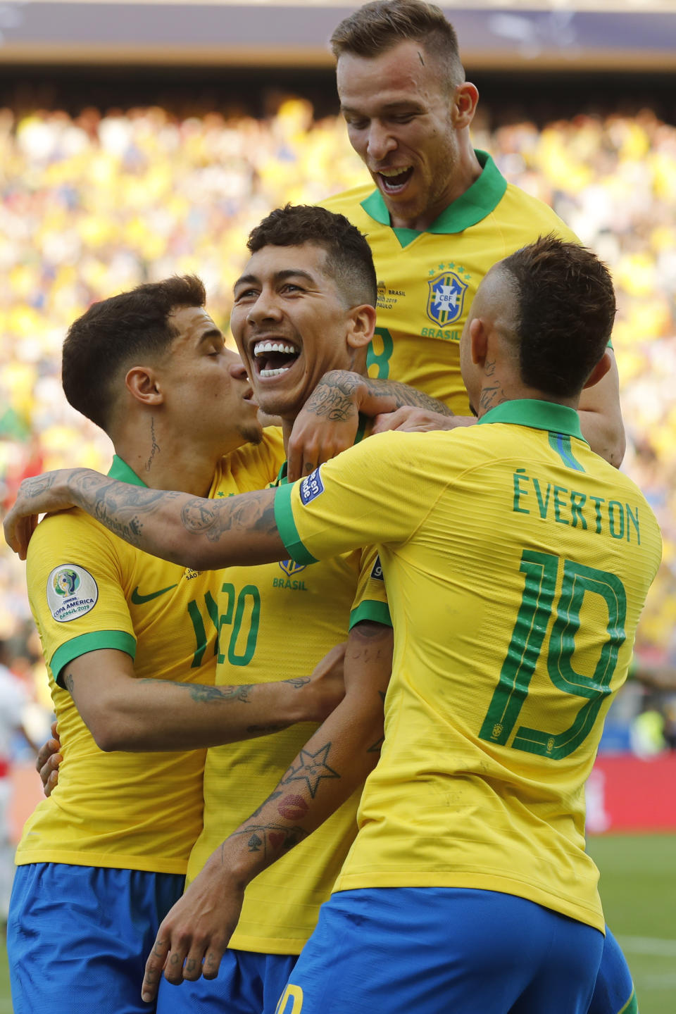 Brazil's Roberto Firmino, center, celebrates with teammates scoring his side's second goal against Peru during a Copa America Group A soccer match at the Arena Corinthians in Sao Paulo, Brazil, Saturday, June 22, 2019. (AP Photo/Victor R. Caivano)