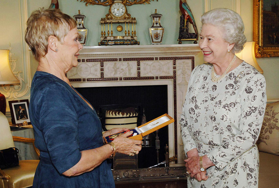 Queen Elizabeth II honors Dame Judi Dench at Buckingham Palace on Oct. 26, 2005. (Photo: Fiona Hanson/Pool/PA)