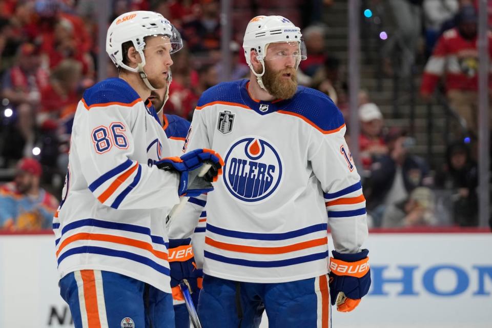 Edmonton Oilers defencemen Philip Broberg (86) and Mattias Ekholm stand on the ice during Game 2 of the Stanley Cup finals on Monday.