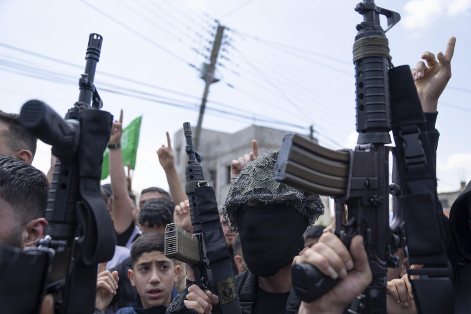 Palestinian gunmen take part in the funeral of Hamas local commander Mohammad Daraghmeh, 26, in the West Bank city of Tubas, Friday, April 12, 2024. Two Palestinians were killed early Friday in confrontations with Israeli forces in the Israeli-occupied West Bank, Palestinian medics and the Israeli military said. The Islamic militant group Hamas said one of those killed was a local commander. (AP Photo/Nasser Nasser)