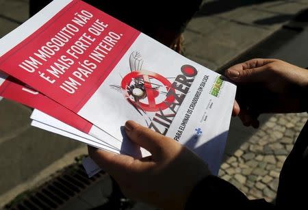 A Brazilian Army soldier shows pamphlets during the National Day of Mobilization Zika Zero in Rio de Janeiro, Brazil, February 13, 2016. REUTERS/Sergio Moraes