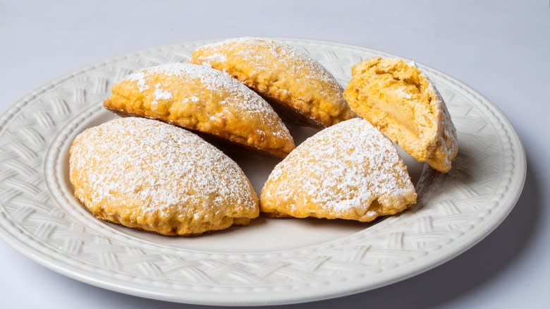 empanadas dusted with powdered sugar