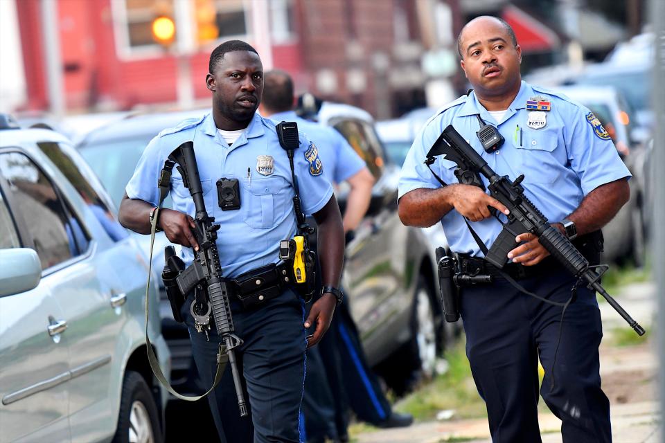 Police officers carrying assault rifles respond to a shooting on August 14, 2019 in Philadelphia, which has registered its highest number of homicides to date since 2007.