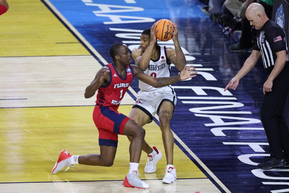 San Diego State forward Keshad Johnson (0) controls the ball as Florida Atlantic guard Johnell Davis (1) defends during the national semifinals of the 2023 NCAA men's tournament at NRG Stadium.