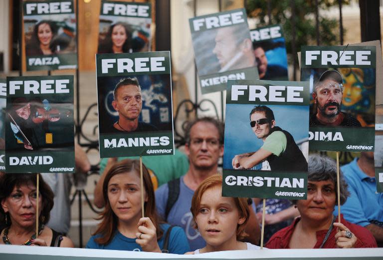 Demonstrators take part in a vigil outside of the Russian Center for Science & Culture on October 5, 2013 in Washington, DC to protest against the arrest of Greenpeace environmentalists and journalists by Russia