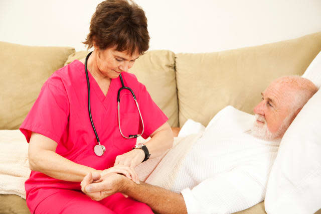 BP1776 Home health nurse taking the pulse of an elderly patient. home; healthcare; nurse; senior; elderly; care; medical; man; wNew life insurance policy from Vitality Life allows you to access payout early to help pay for care