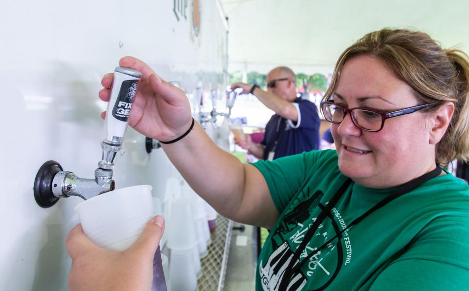Volunteer Bridget Condon keeps the beer flowing during the 13th annual Waukesha Rotary BluesFest in Delafield in 2019. The two-day festival is set for Aug. 12-13 this year.