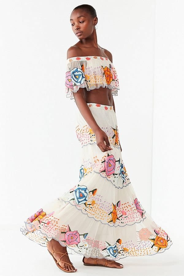 Get the matching set <a href="https://www.urbanoutfitters.com/shop/uo-embroidered-maxi-skirt?category=two-piece-dress-sets&amp;color=011" target="_blank">here</a>.