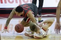 Ohio State's CJ Walker and Wisconsin's Brad Davison go after a loose ball during the second half of an NCAA college basketball game Saturday, Jan. 23, 2021, in Madison, Wis. (AP Photo/Morry Gash)