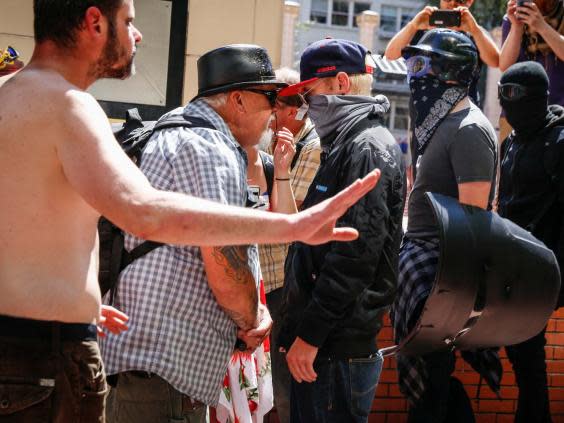 An unidentified right aligning man faces off with Rose City Antifa members at Pioneer Courthouse Square on 29 June in Portland, Oregon (Moriah Ratner/Getty Images)