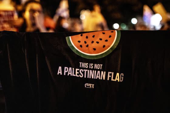 Protestors with watermelon illustrations, symbolizing the Palestinian flag, in Tel Aviv, Israel on Aug. 12, 2023. <span class="copyright">Mustafa Alkharouf/Anadolu Agency/Getty Images</span>