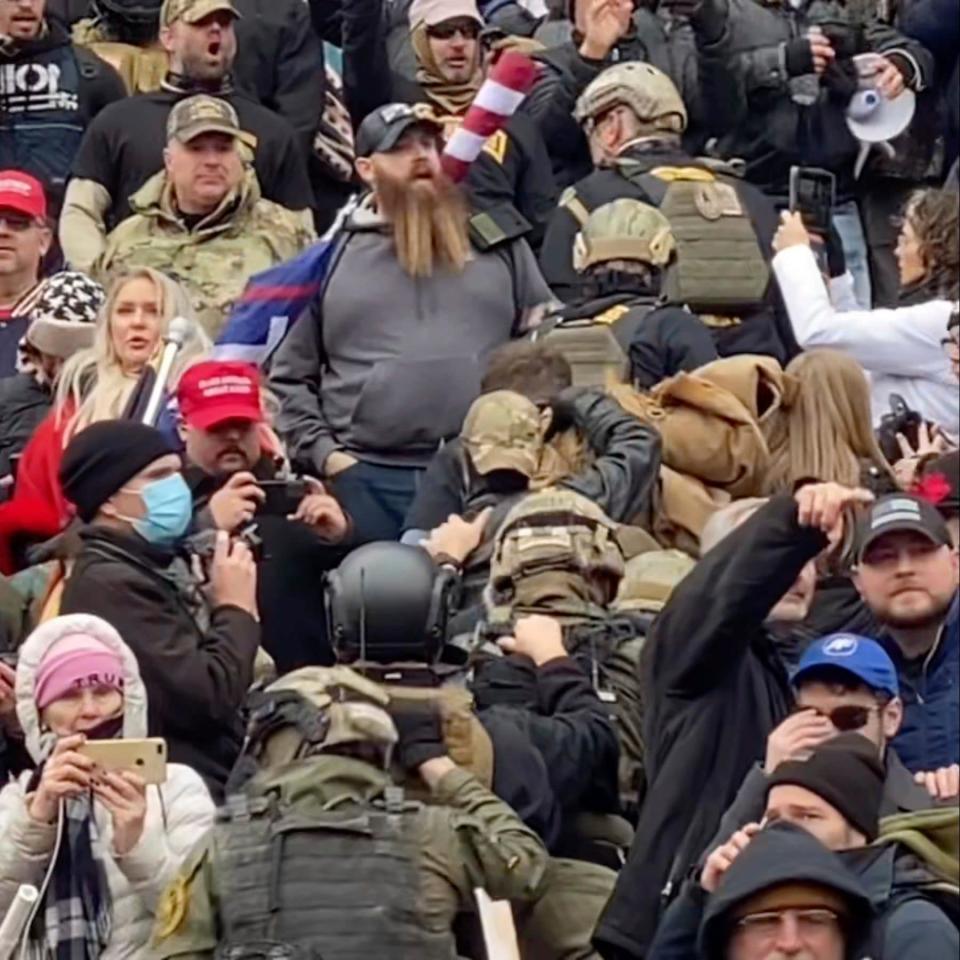 image from video provided by Robyn Stevens Brody, a line of men wearing helmets and olive drab body armor walk up the marble stairs outside the U.S. Capitol - Robyn Stevens Brody 