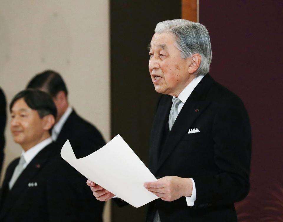 Japan's Emperor Akihito speaks during the ceremony of his abdication in front of other members of the royal families and top government officials at the Imperial Palace in Tokyo, Tuesday, April 30, 2019. The 85-year-old Akihito ends his three-decade reign on Tuesday as his son Crown Prince Naruhito, left, will ascend the Chrysanthemum throne on Wednesday. (Japan Pool via AP)