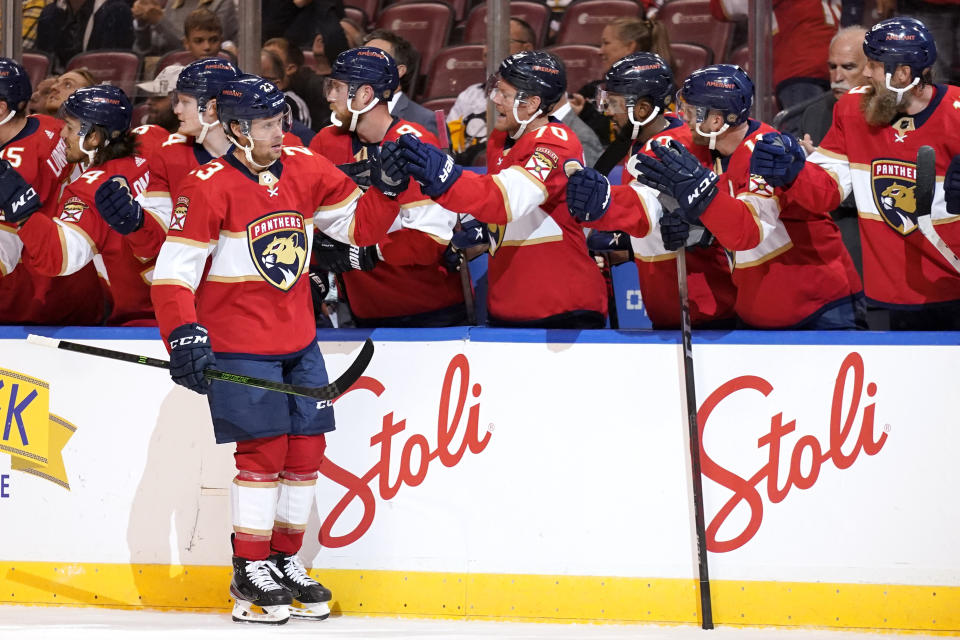 Florida Panthers left wing Carter Verhaeghe (23) is congratulated after scoring a goal during the first period of an NHL hockey game against the Pittsburgh Penguins, Thursday, Oct. 14, 2021, in Sunrise, Fla. (AP Photo/Lynne Sladky)