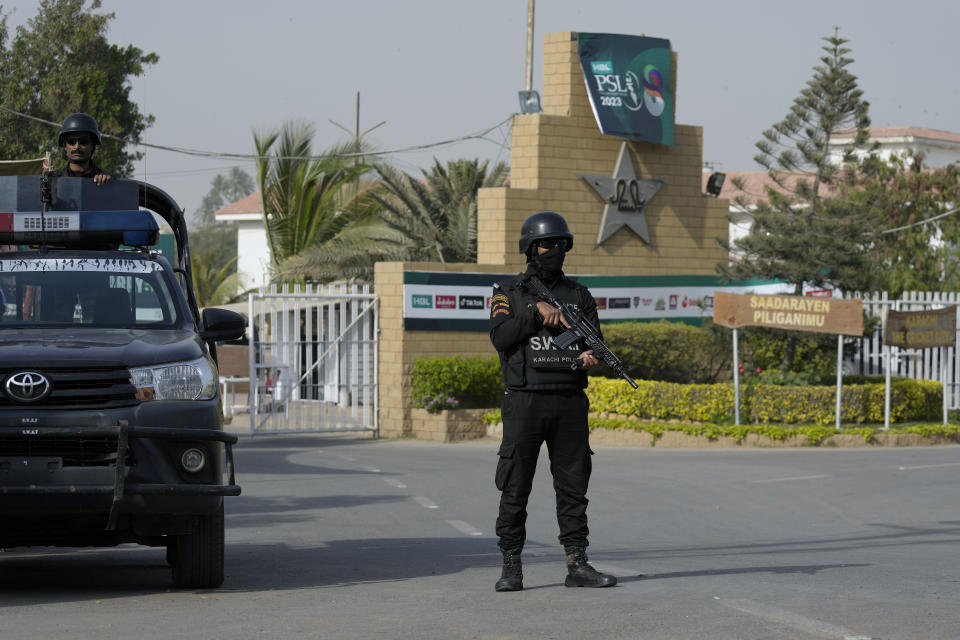 Police commandos stand guard at the main entrance of the National Stadium to ensure security, where teams with foreign players attending practice session for upcoming Pakistan Super League, in Karachi, Pakistan, Saturday, Feb. 11, 2023. Karachi will host the first leg of nine matches of Pakistan Super League Twenty20 cricket tournament, beginning from Monday. (AP Photo/Fareed Khan)