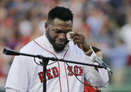 FILE - In this June 23, 2017, file photo, Boston Red Sox baseball great David Ortiz wipes a tear at Fenway Park in Boston as the team retires his number "34" worn when he led the franchise to three World Series titles. Ortiz was back in Boston for medical care after authorities said the former Red Sox slugger affectionately known as Big Papi was ambushed by a gunman at a bar in his native Dominican Republic. A plane carrying the 43-year-old retired athlete landed Monday night, June 10, 2019, after a flight from the Dominican Republic, the team said. (AP Photo/Elise Amendola, File)
