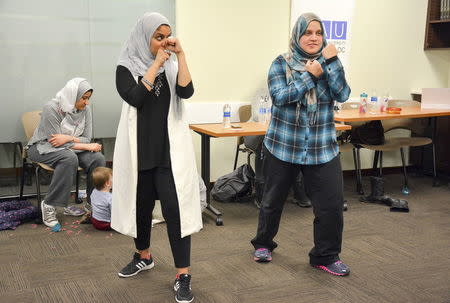 Egyptian-American community activist Rana Abdelhamid (L) demonstrates a move during a self-defense workshop designed for Muslim women in Washington, DC, March 4, 2016 in this handout photo provided by Rawan Elbaba. Picture taken March 4, 2016. REUTERS/Rawan Elbaba/Handout via Reuters