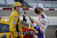 Kyle Busch, left, and Denny Hamlin talk prior to the start of a NASCAR Cup Series auto race Saturday, Sept. 12, 2020, in Richmond, Va. (AP Photo/Steve Helber)