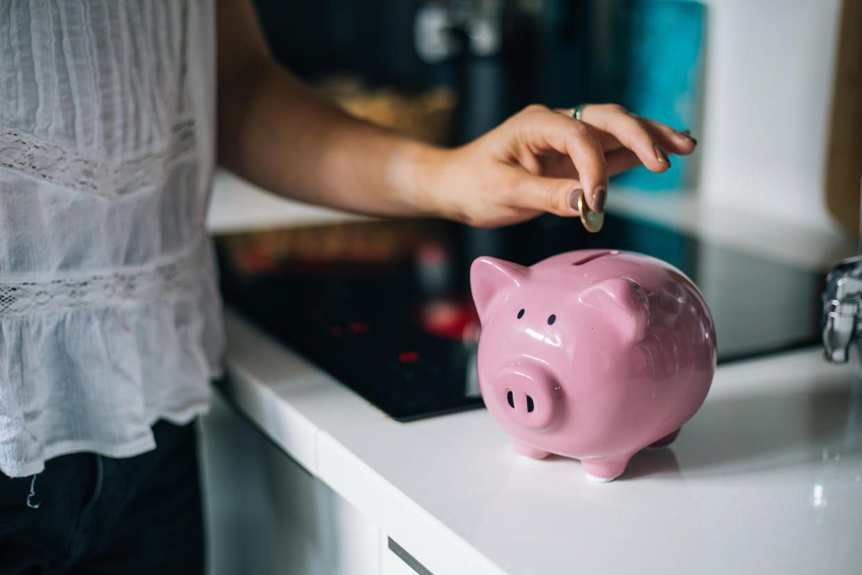 Woman saving money in a piggybank Savings accounts