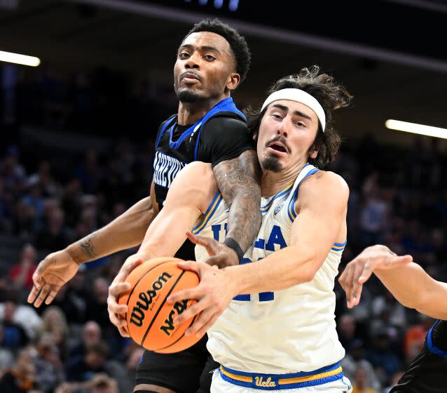 Sacramento California March 16, 2023-UCLA's Jaime Jaquez Jr. battles for a rebound with UNC Asheville's Jamon Battle in the first half of the first round of the NCAA Tournament in Sacramento Thursday. (Wally Skalij/Los Angeles Times)