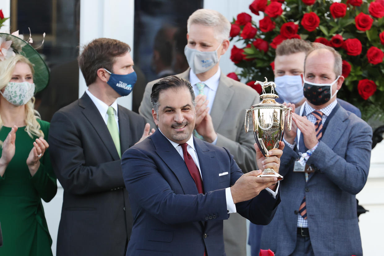 Amr Zedan, Saudi Arabian businessman and owner of Medina Spirit, raises the trophy after winning the 147th running of the Kentucky Derby at Churchill Downs on May 1, 2021 in Louisville, Kentucky. (Andy Lyons/Getty Images)