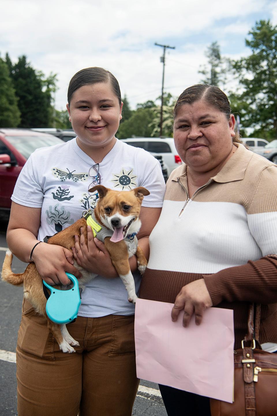 Wendy Acevedo waits with her mother, Marina Lule, both of Canton, and their dog, Loki, at the affordable pet care clinic May 17, 2023.
