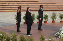 U.S. Secretary of State Mike Pompeo, center, and Secretary of Defence Mark Esper pay their tributes at the National War Memorial in New Delhi, India, Tuesday, Oct. 27, 2020. In talks on Tuesday with their Indian counterparts, Pompeo and Esper are to sign an agreement expanding military satellite information sharing and highlight strategic cooperation between Washington and New Delhi with an eye toward countering China. (Adnan Abidi/Pool via AP)