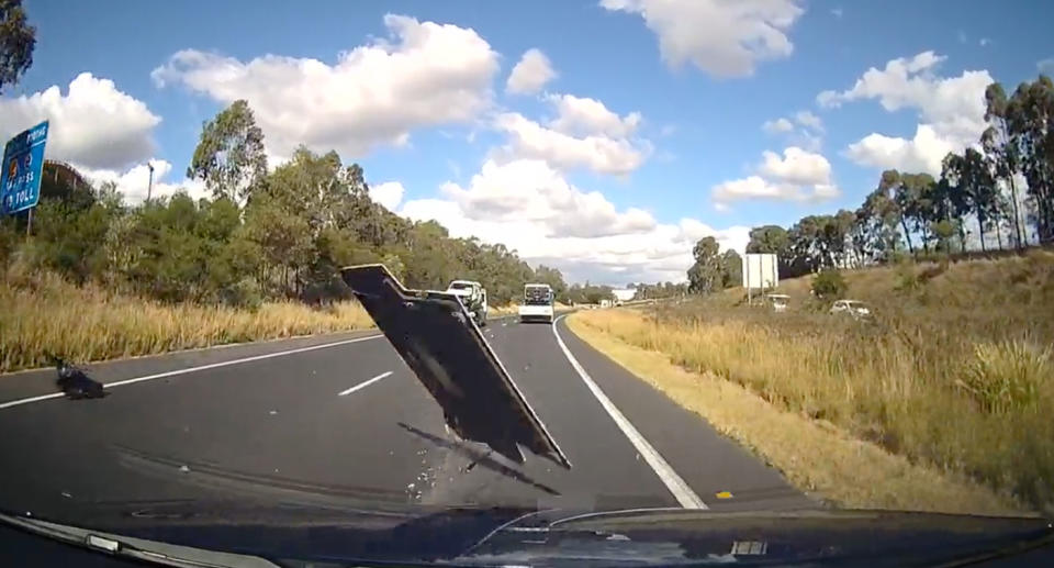 Dash cam footage of the metal ute boot cover spinning toward the car.